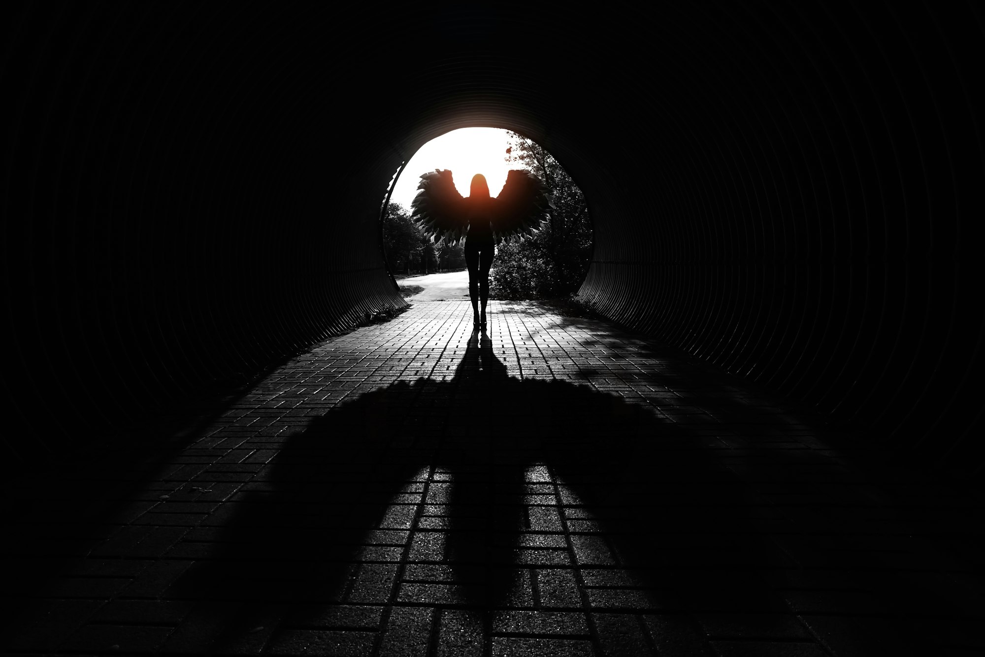 Angel silhouette with shadow in the tunnel
