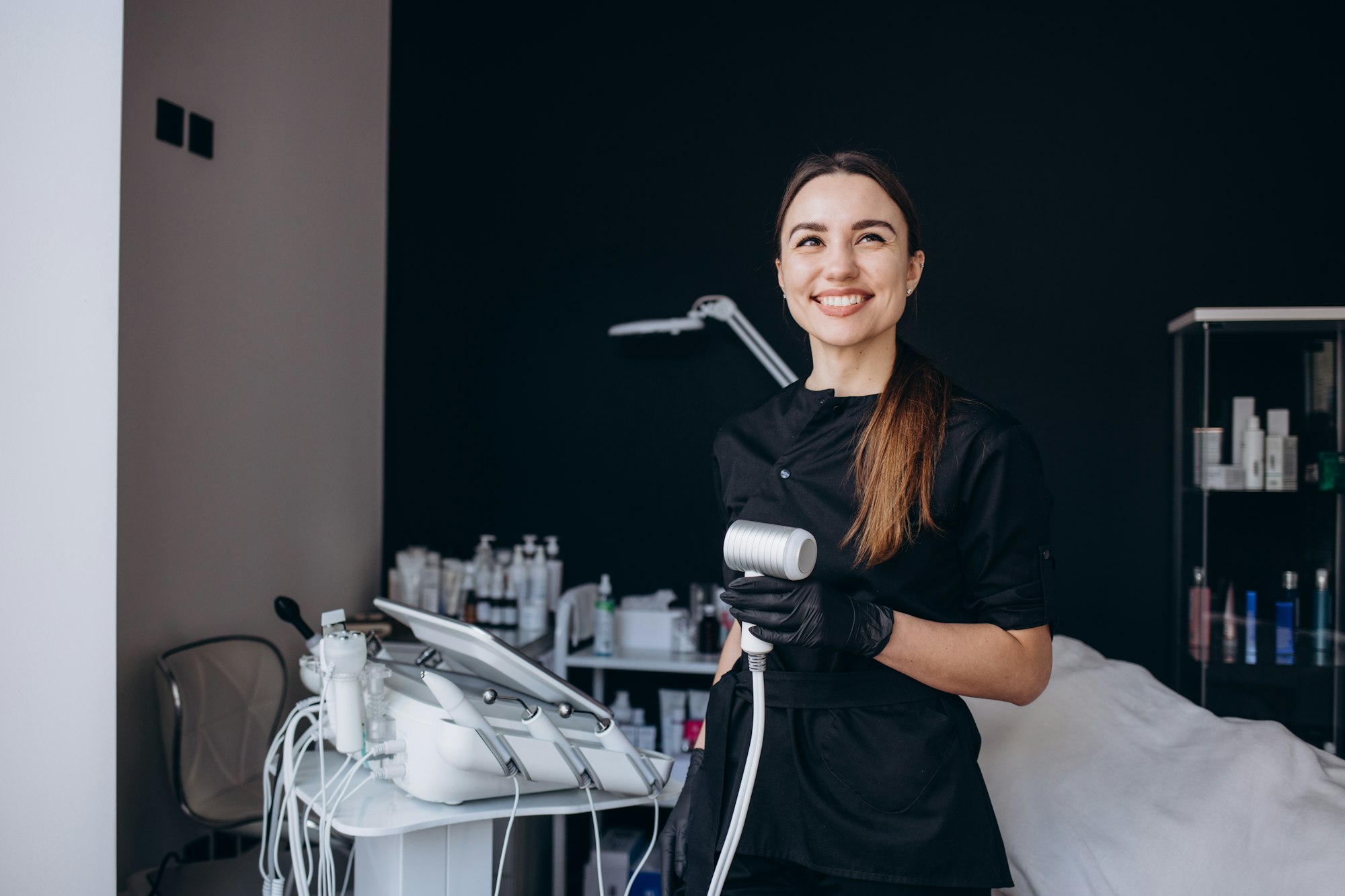 portrait of a cosmetologist with a cryotherapy device in his hands