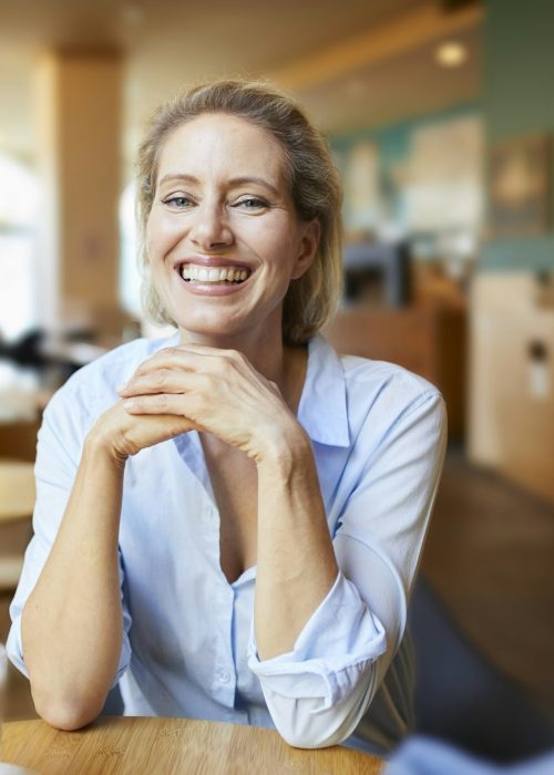 Portrait of happy woman in a cafe